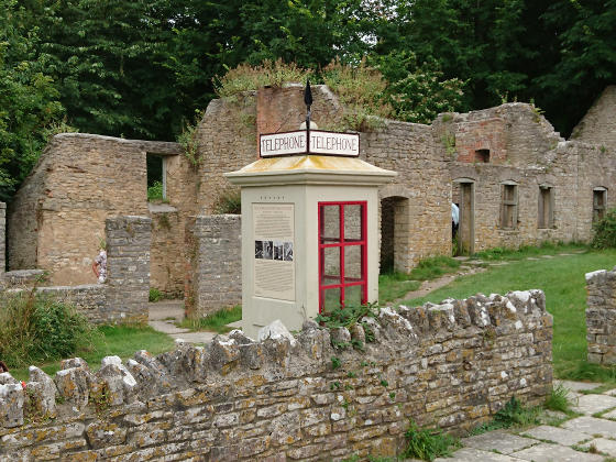 An old-fashioned telephone box inside a ruin